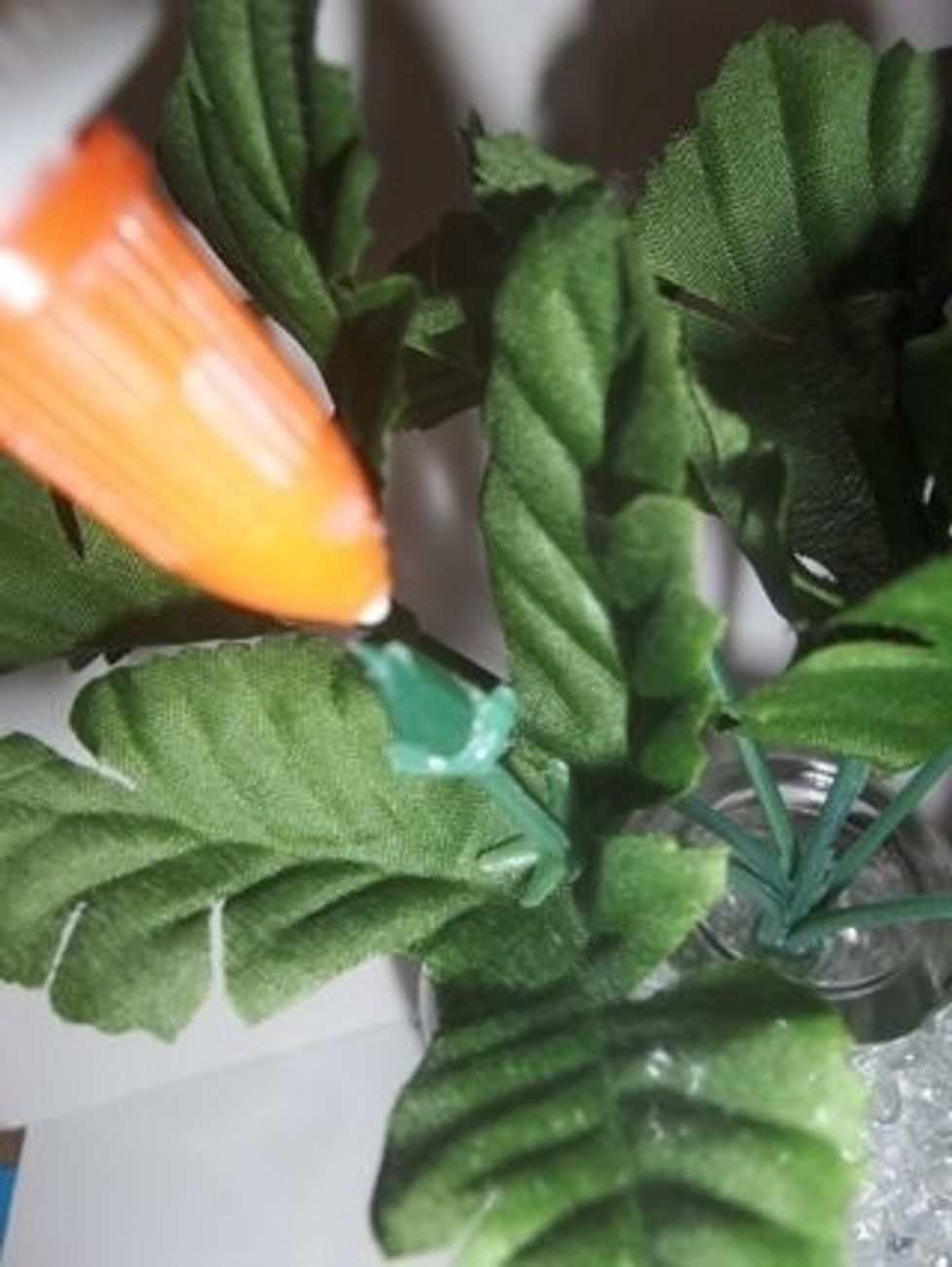 Put a little glue on the stem to help the flower stay on better.