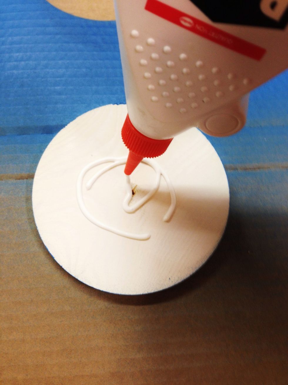 Put a little wood glue on the back of the coasters