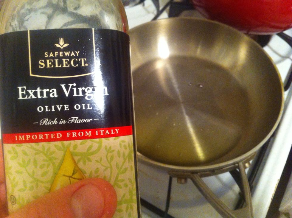 Put a medium pan on medium heat. After it's heated up, add a medium amount of olive oil. Put your chicken in face down.    (Medium)