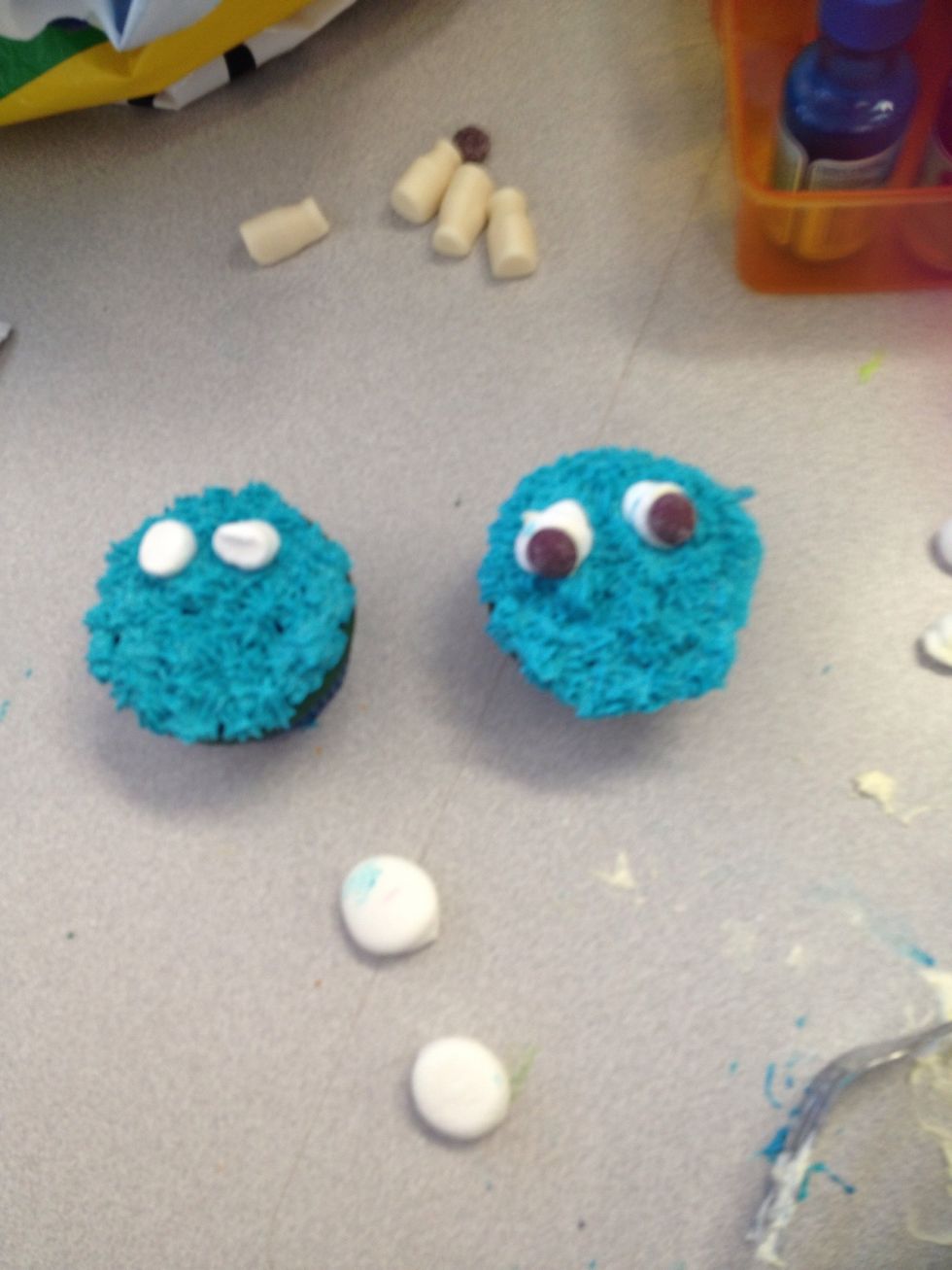 Put a mini marshmallow on for eyes and squish one using knife and place on top of mini marshmallow and place a purple sour skittle on to make the eye ball