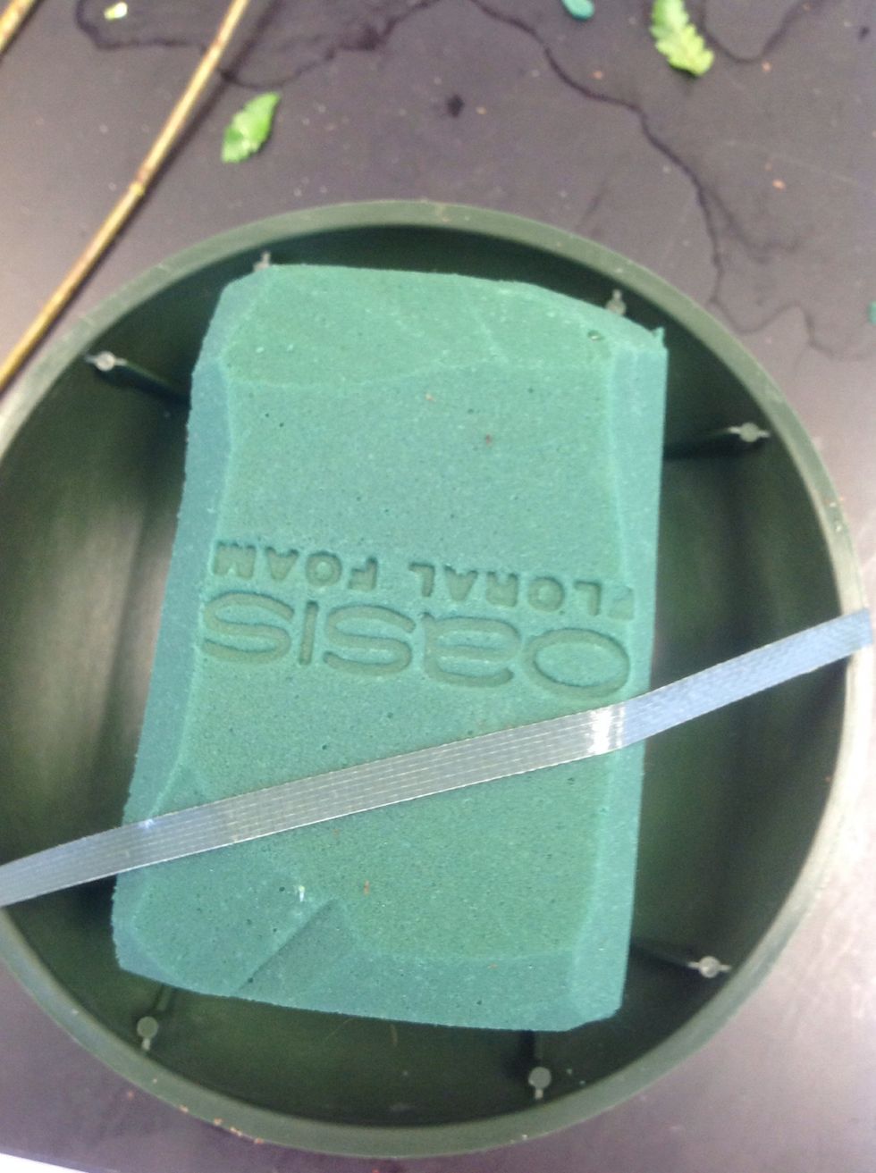 Put a piece of anchor tap over the foam. This step is important if you are moving your arrangement somewhere. It will keep it in place better. Don't place it over the center.