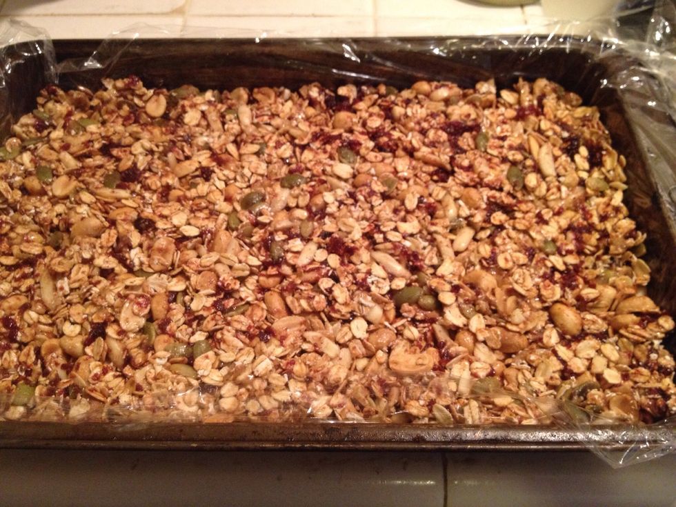 Put a piece of plastic foil in a baking pan, spread the granola mix in it evenly and put it in the freezer for 15 minutes
