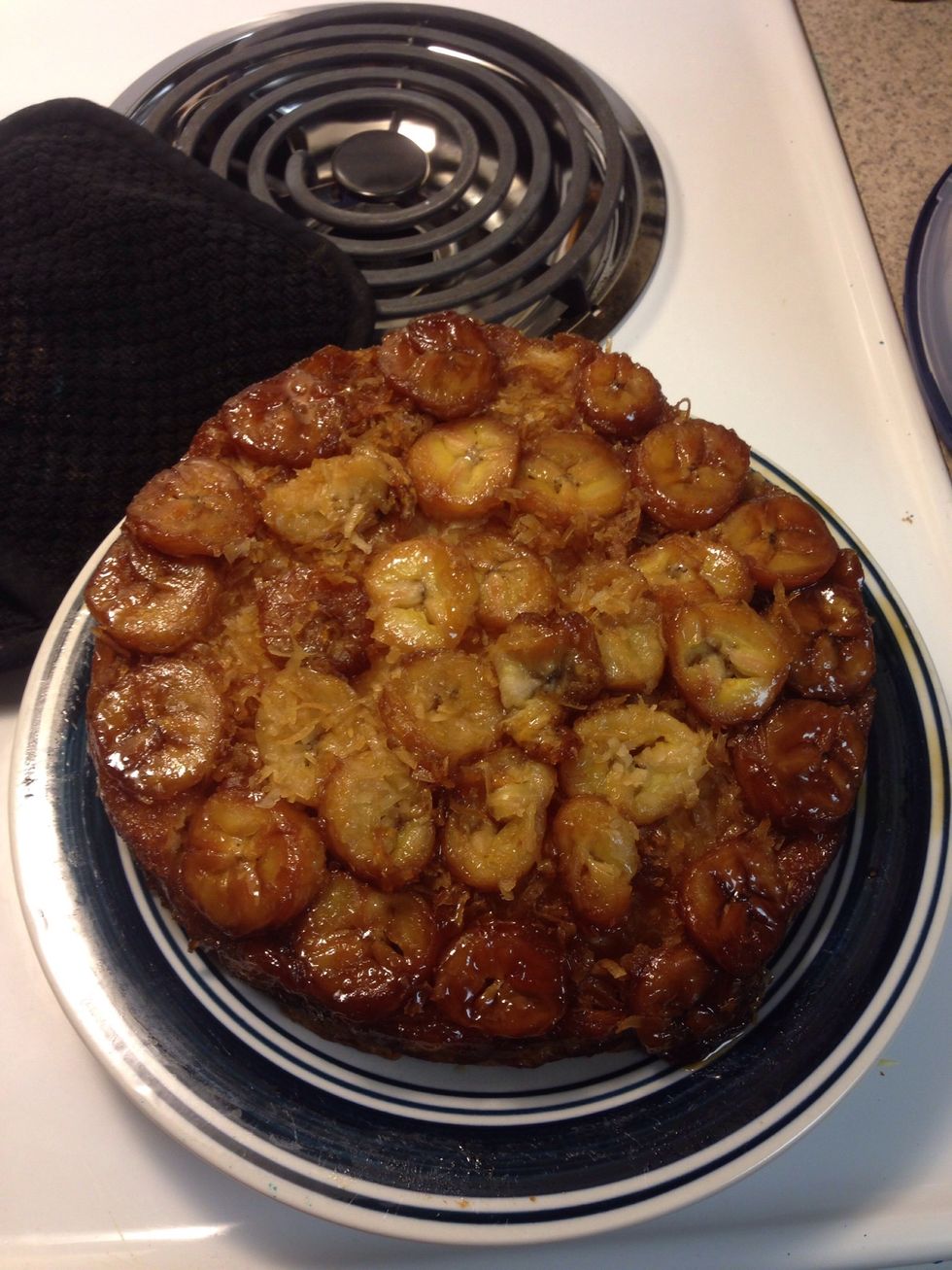 Put a plate on top on the cake pan and flip the cake.