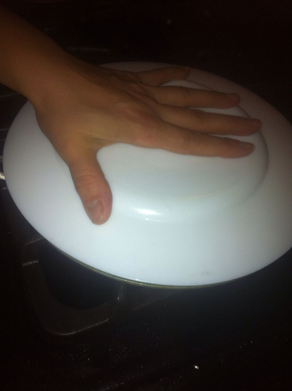 Put a plate over the pan, flip onto the plate, then slide the omelette back into the pan. Don't worry if there's some eggy mixture on your plate. It happens.