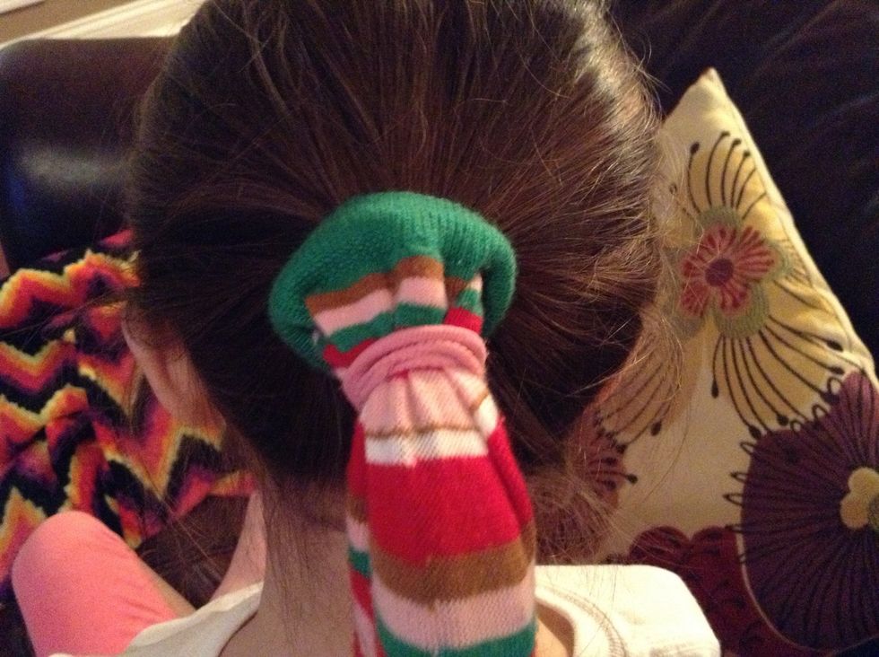 Put a ponytail on top of sock.