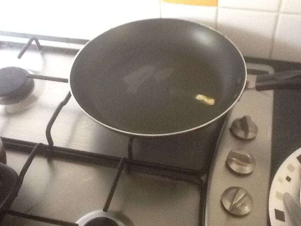 Put a quarter of a teaspoon of butter on a frying pan until it melts. (You can use any oily substance).