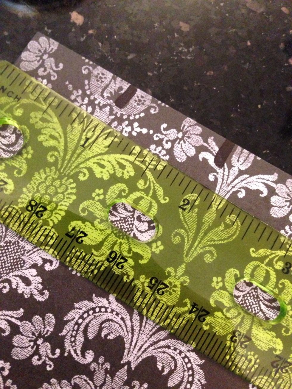Put a ruler horizontally at the top of the paper and make a mark at every inch.