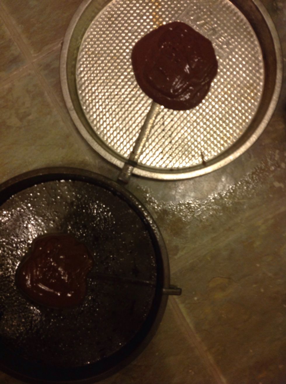 Put a scoop of chocolate into both round cake pans.