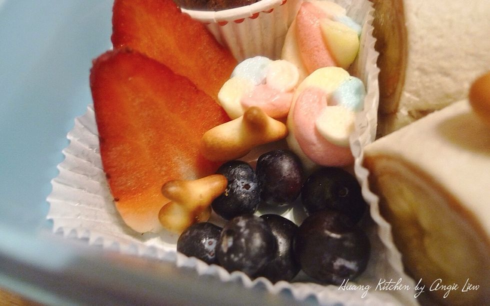 Put a serving of your kid's favourite fruits on another cupcake liner at the other corner of the lunchbox.