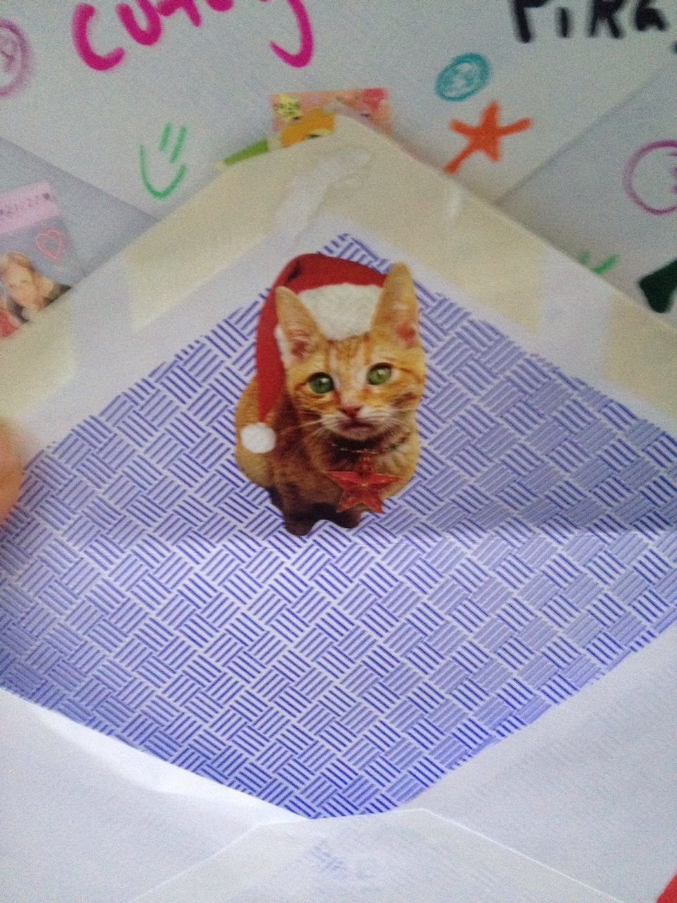 Put a sticker inside each envelope under the flap, and glue all 24 onto poster board.  I was able to fit all the envelopes by making three columns and eight rows. Put a drop of hot glue on each corner