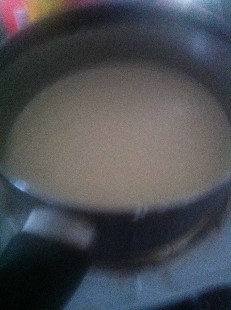 Put a stove on high heat then add double cream and milk.