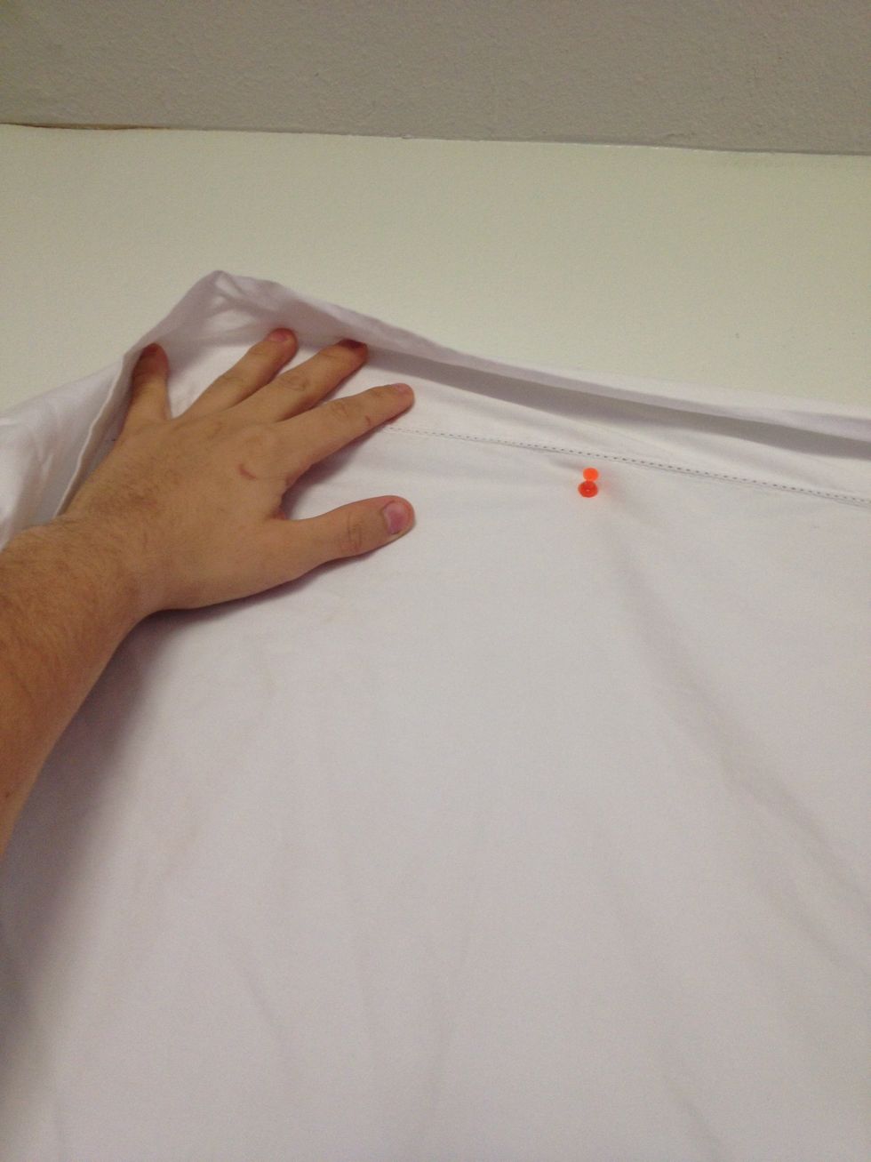 put a tac at the corner of the sheet. make sure to hang it high.