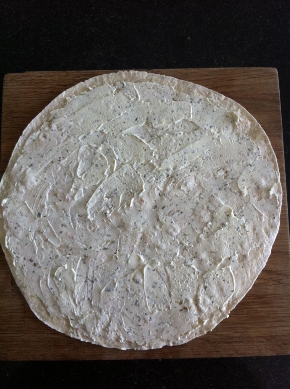 Put a thick layer of the cheese spread on the wrap, make sure you divide it equally.