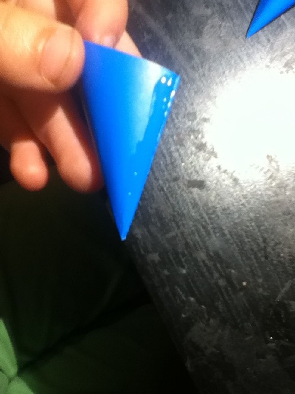 Put a thin strip of glue on one edge of one of your cones.