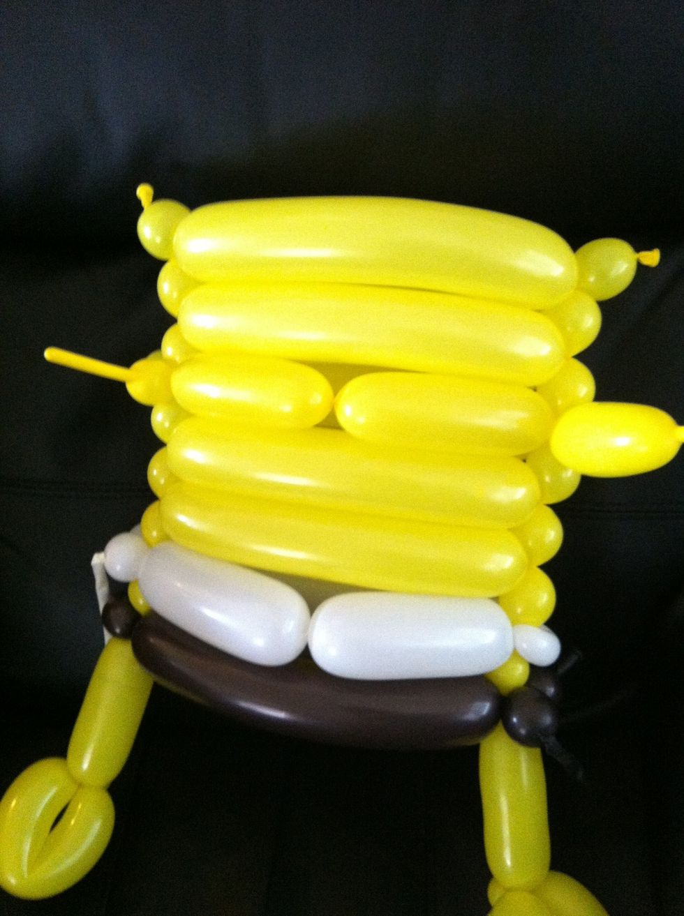 Put a twist in the center of the white balloon and the middle yellow bubble