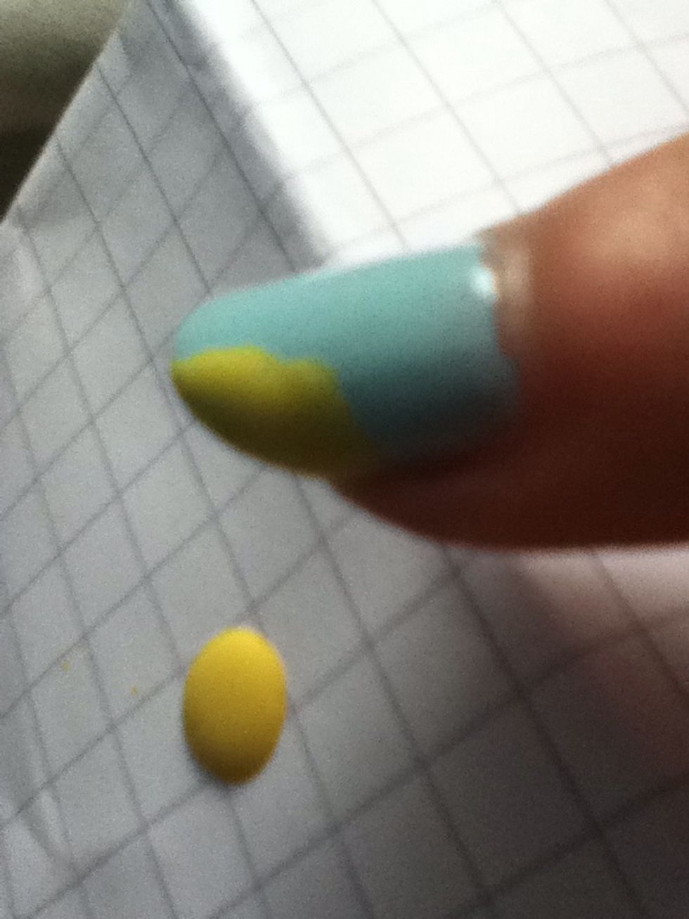 Put a yellow blob in the corner of you first nail. Don't worry if it's not very neat you can sort that out in the next step.