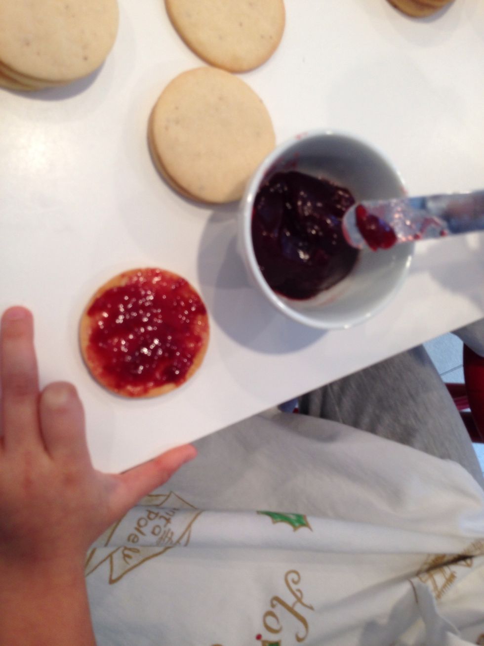 Put about that much jam on the bottoms then put on tops . Oops, what happened to Hildegard's index finger? Maybe she also assists a carpenter?