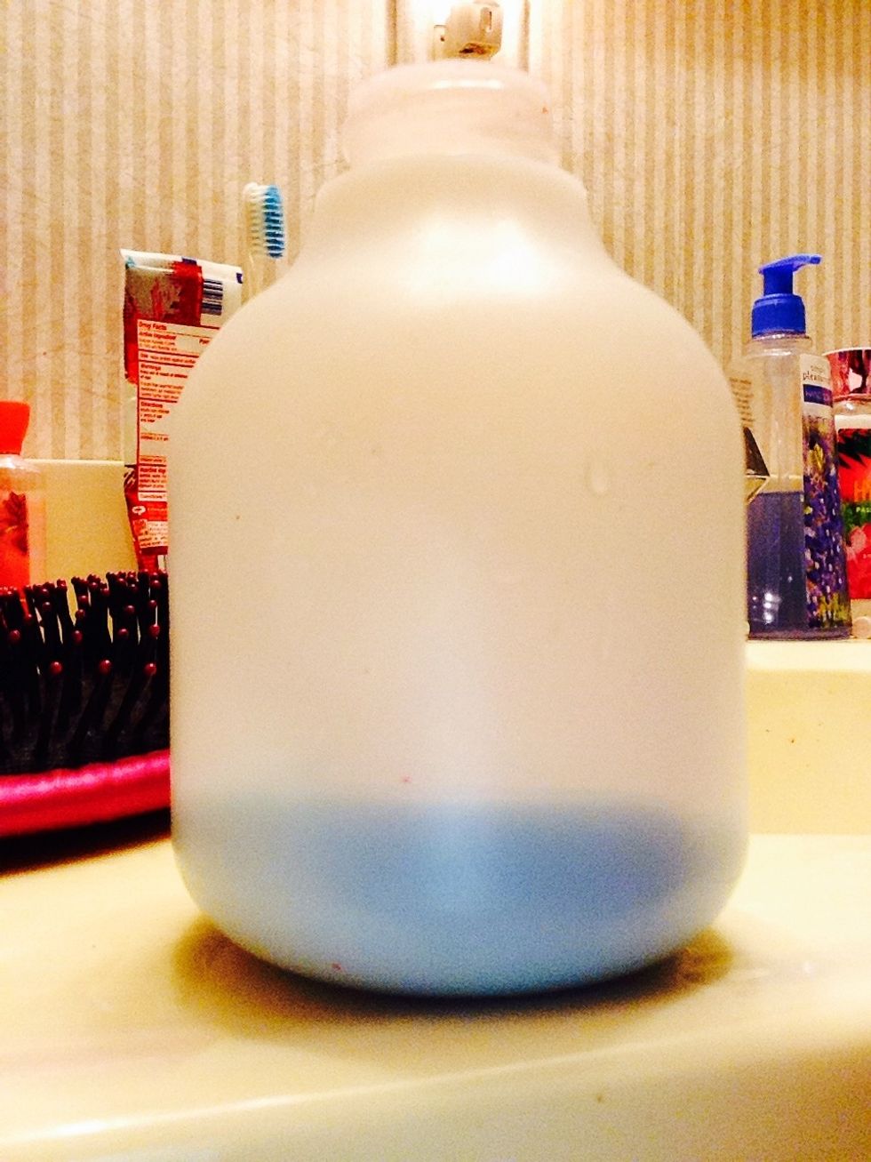 Put about two tablespoons of conditioner in the water bottle.