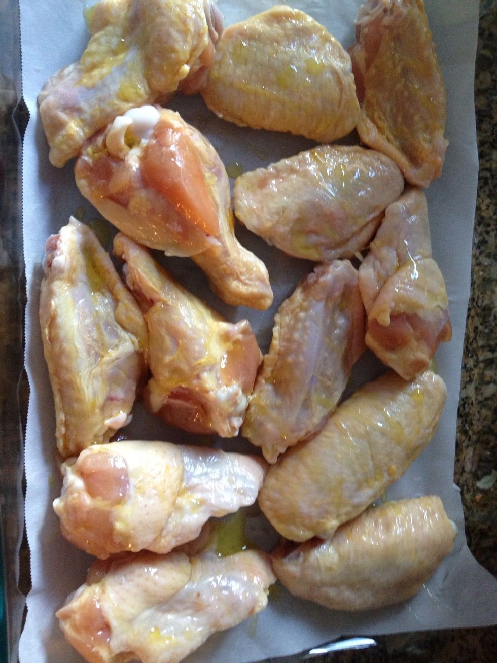 Put all chicken in a baking dish, I like to use parchment paper so that they don't stick, also drizzle olive oil on the wings before seasoning.