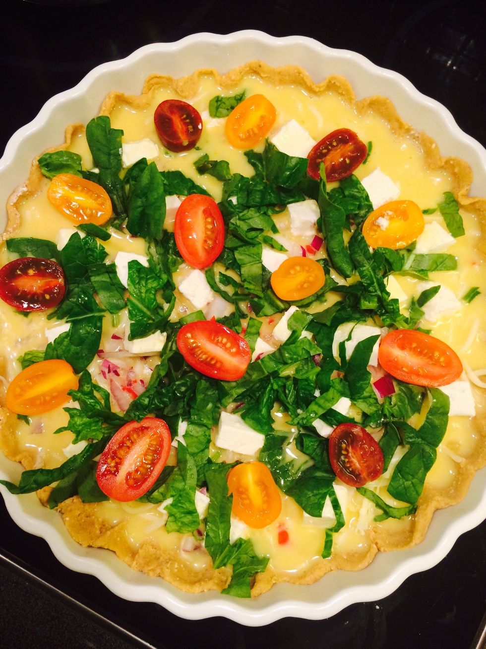 Put all ingredients in the pie-tin (I layered it like this: shredded mozzarella, chilli, onion, feta cheese, spinach, tomatoes with egg-mix on top). Cook on 220 degrees celcius for 20-30 mins.