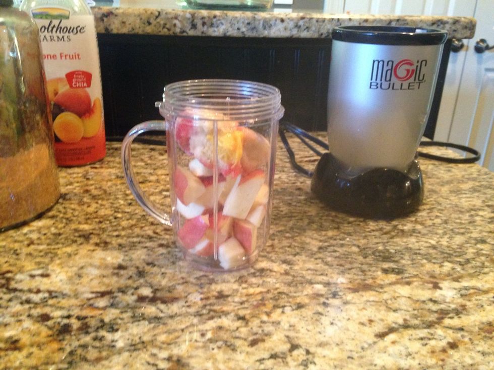 Put all of the fruit and greens into the blender. Usually I like it with strawberries and blueberries, but I don't have any right now!