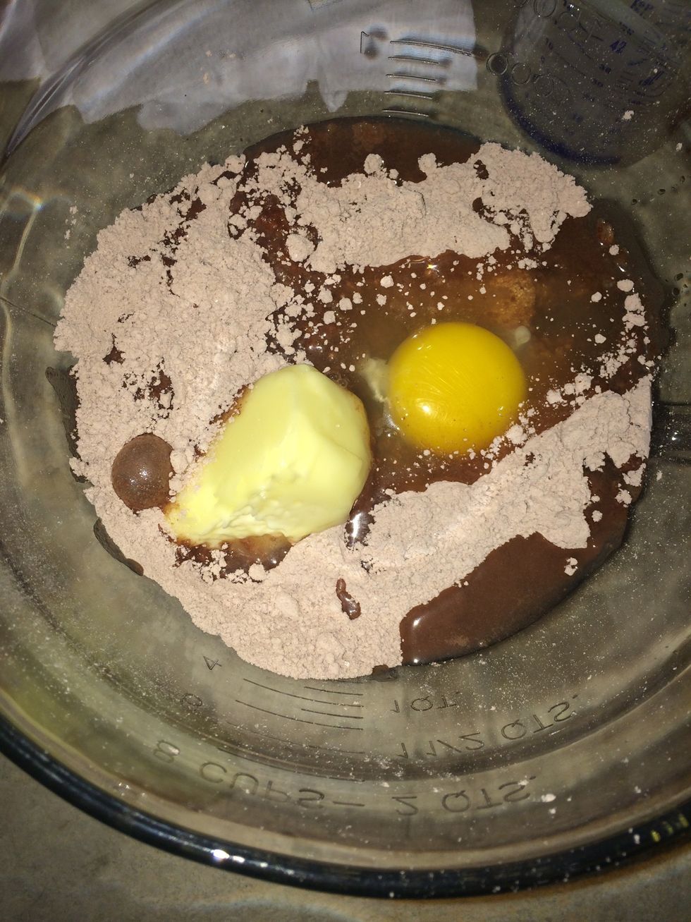 Put all the brownie ingredients (2 tbs water, 1/2 stick butter, egg) into a bowl for mixing.