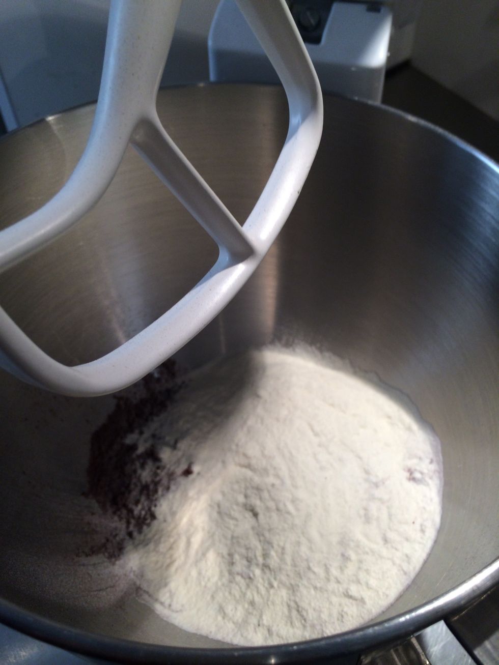 Put all the dry ingredients in a mixer run to mix them add the eggs then the melted butter