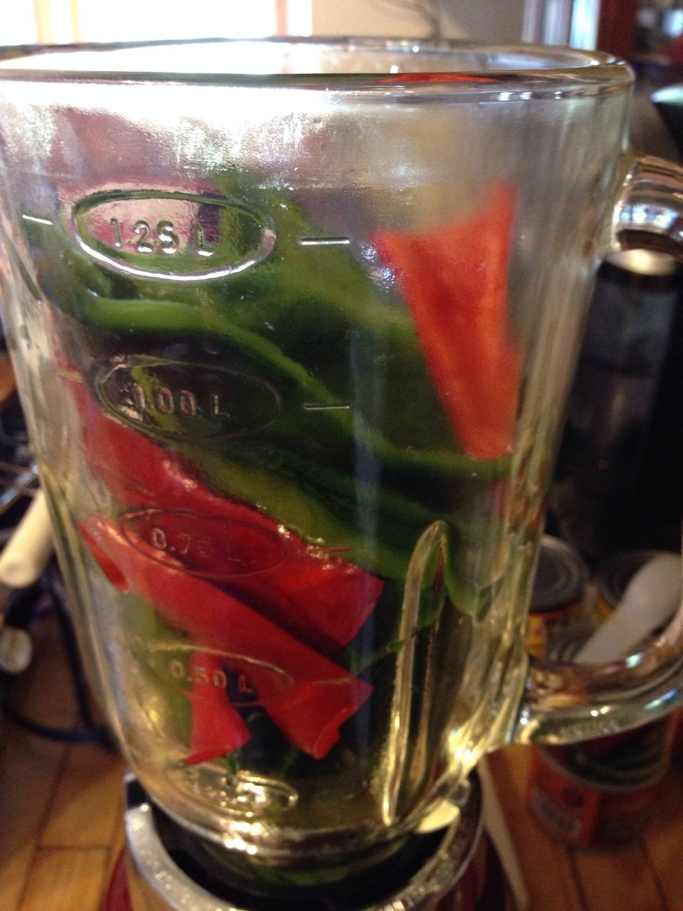 Put all the peppers into the blender. Add 1/4 cup of the soaking liquid to the blender. Begin to pur\u00e9e the peppers.