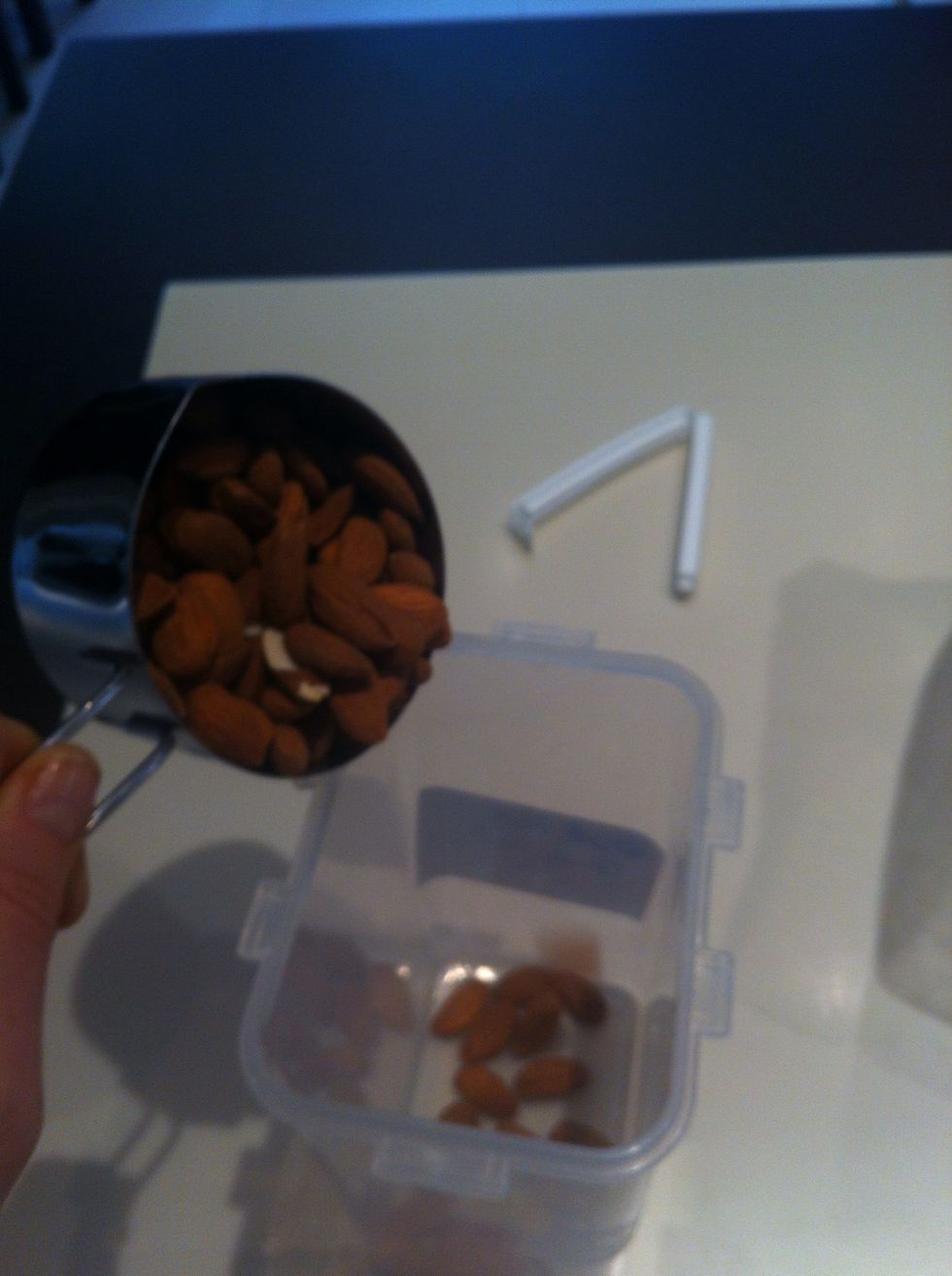 Put almonds in a tub or glass jar
