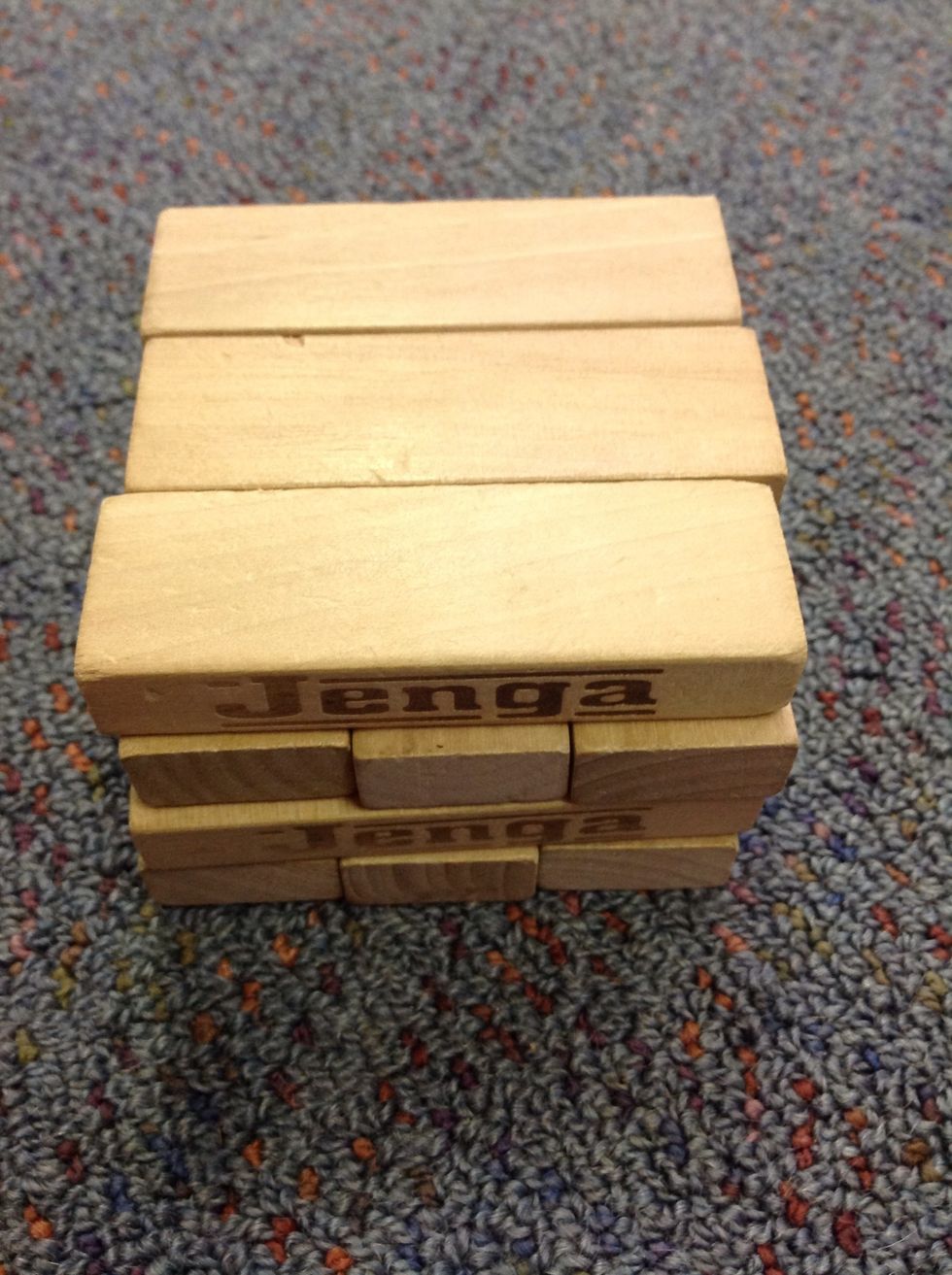 Put another three on going the other way you janga tower should look like this so far if not you can knock it over and start again so it looks like this