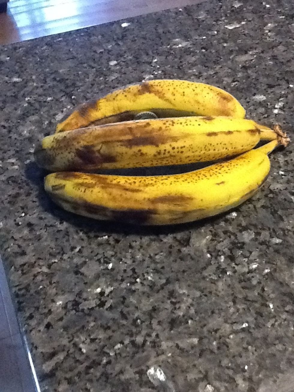 Put bananas in the freezer for a few days until the skin is black and mushy. You can put them in a paper bag in the refrigerator for a day or two to speed the process.