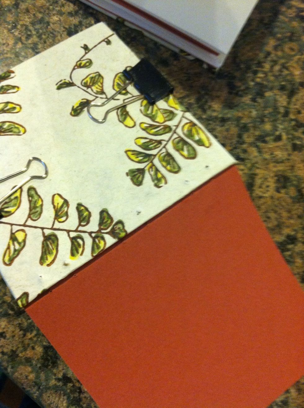 Put binding clips on one 1/2 of the first signature and front cover