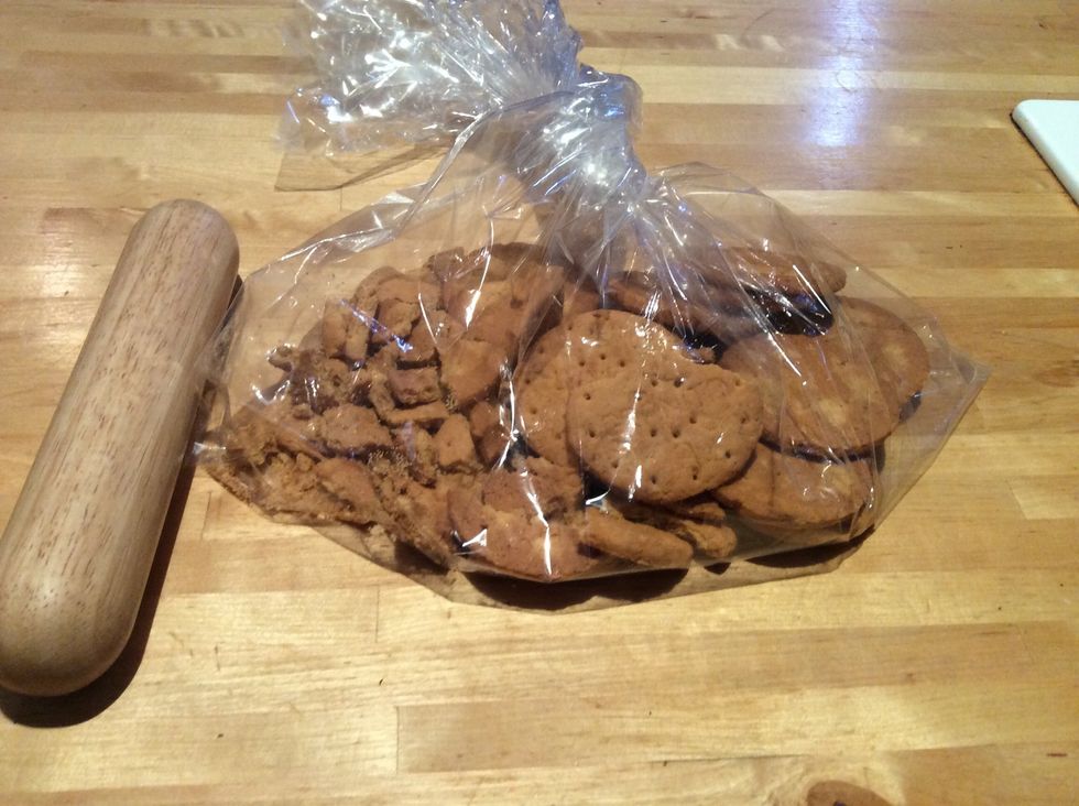 Put biscuits in a clean plastic bag and crush them with a rolling pin. Crush until the biscuits are like bread crumbs.