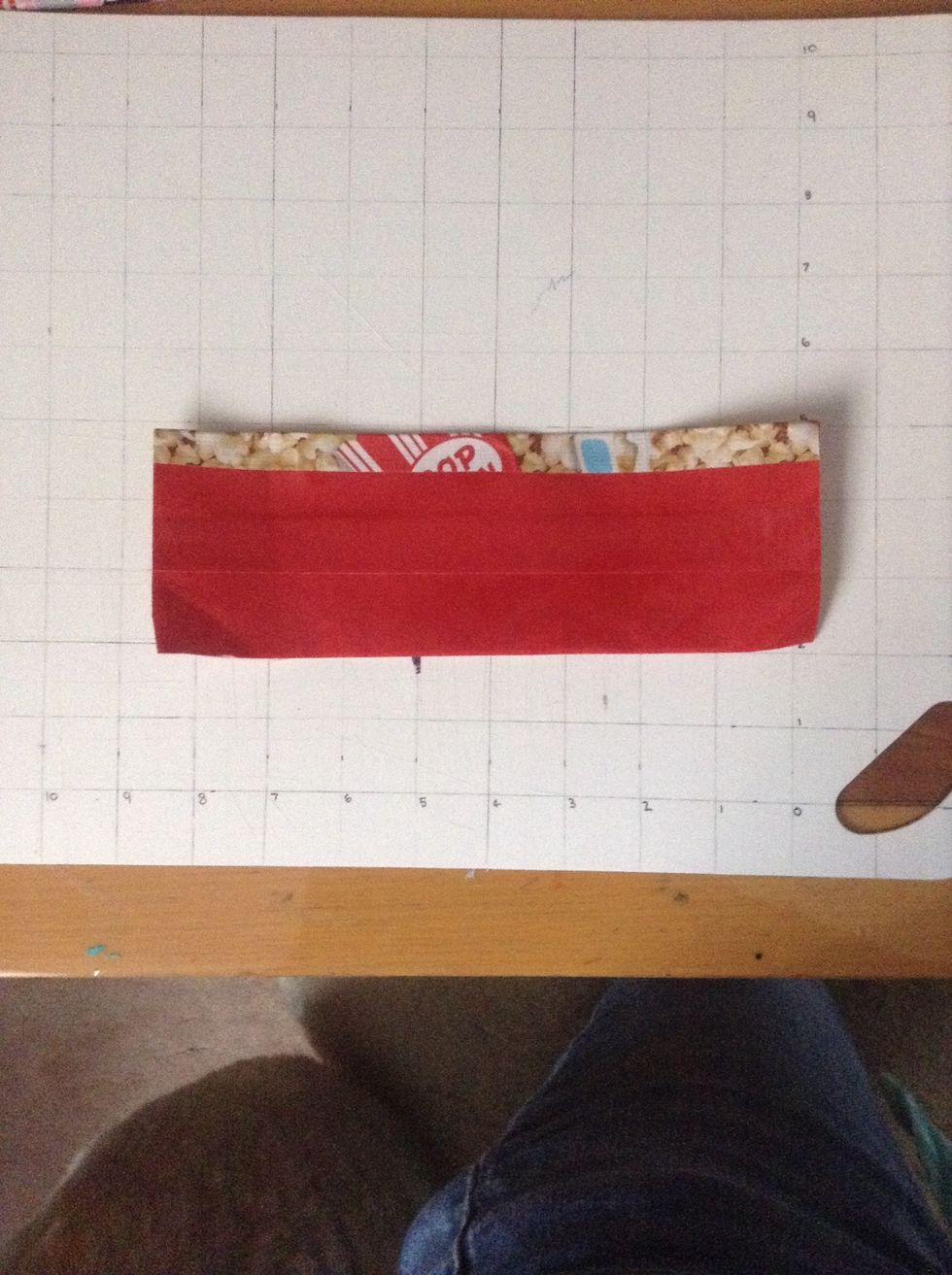 Put both of the pieces together and there should be a .5 inches of tape showing at the top, fold that over on the red side.