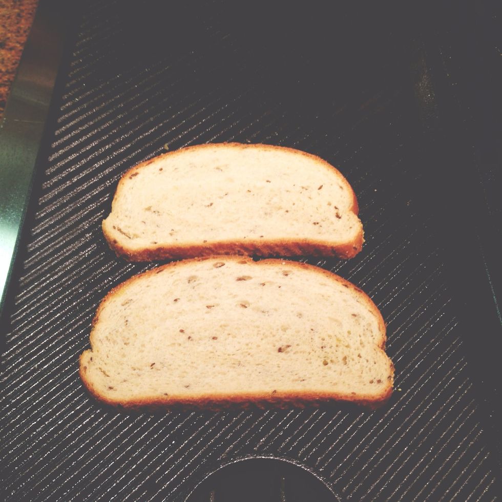 put bread with olive oil face down on grill. bring heat down to low.