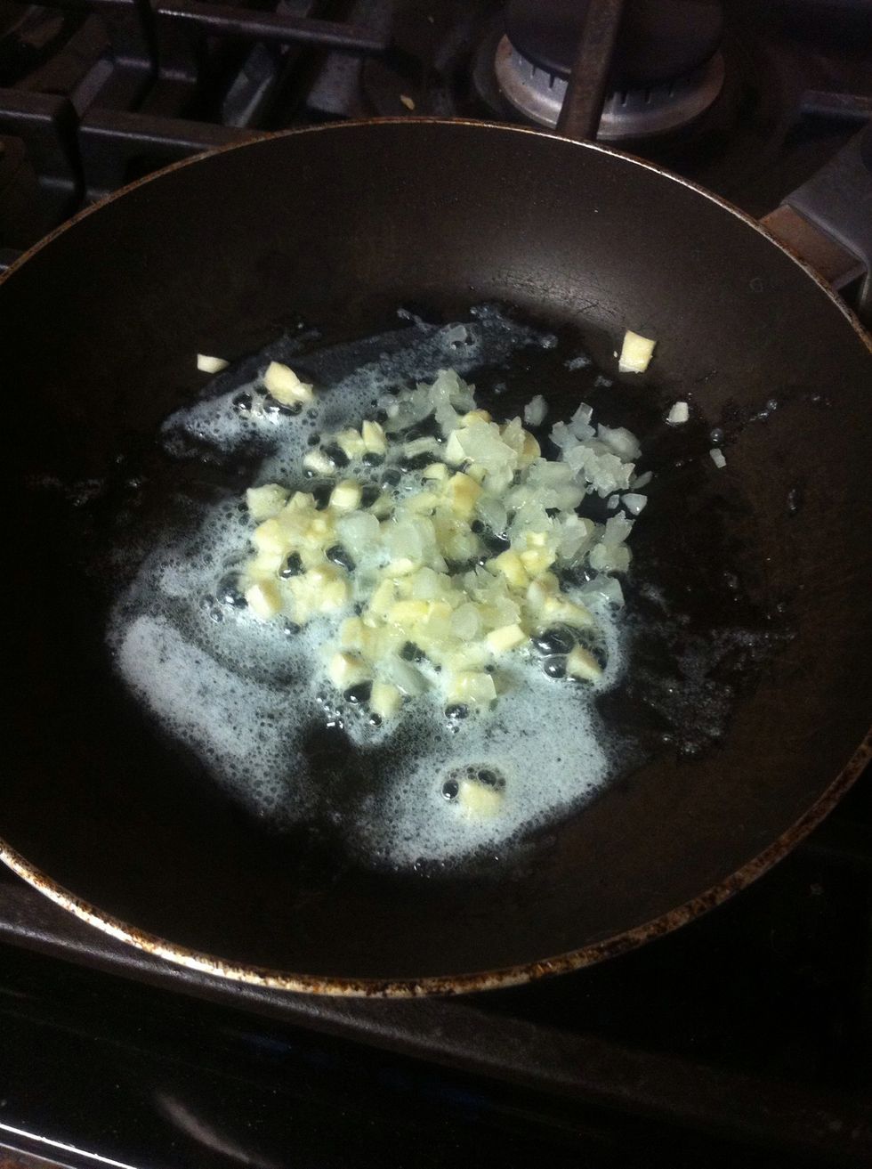 Put butter in a pan until it melts then put the garlic in and stir it