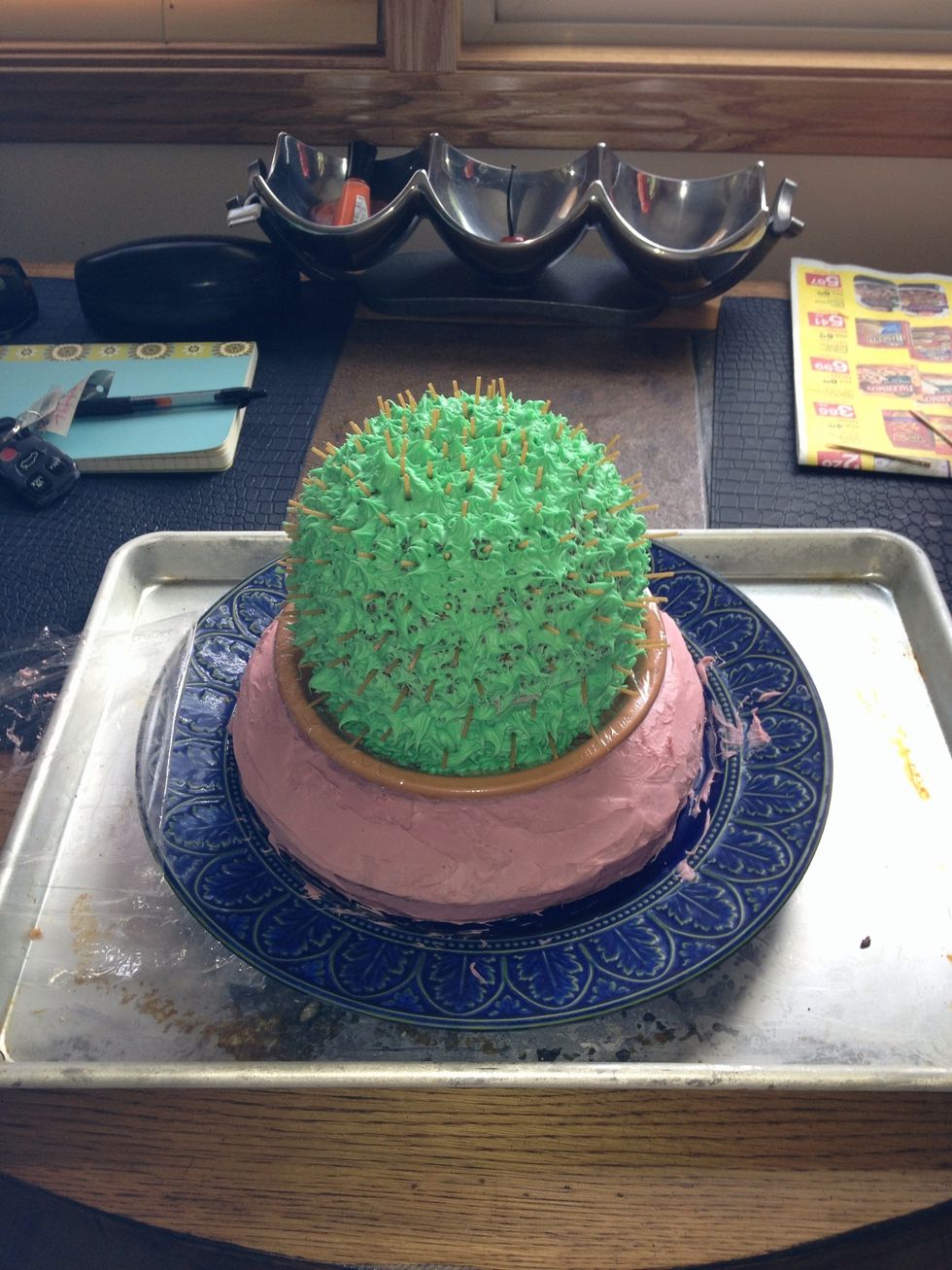 Put cactus cake on top of round cake.