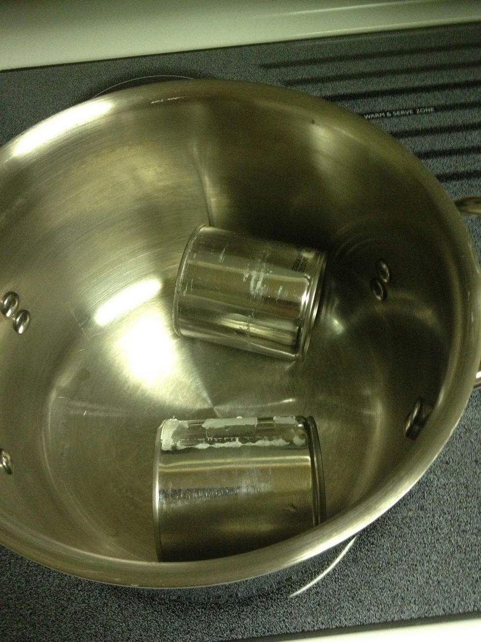 Put cans in large pot. It is very important that cans lay sideways. This allows cans to rotate and cook evenly. It also helps alleviate pressure to keep the cans from becoming volatile.