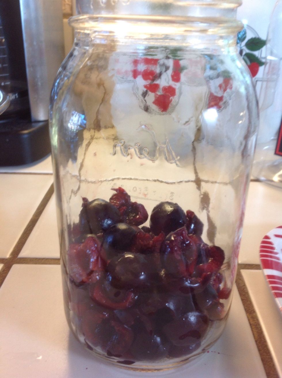 Put cherries in glass jar.