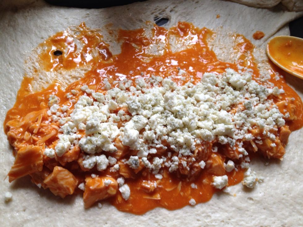 Put chicken mixture down on the pizza dough. Add blue cheese crumbles to the top.