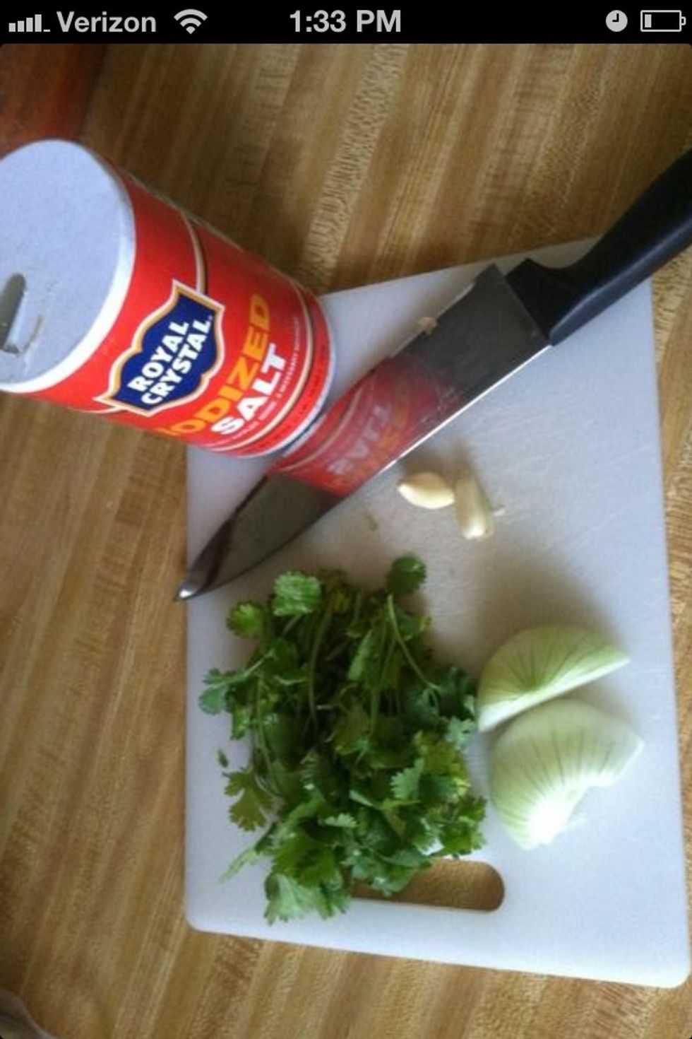 Put cilantro, garlic, salt and onion in a blender along with the jalape\u00f1o and tomatillo.