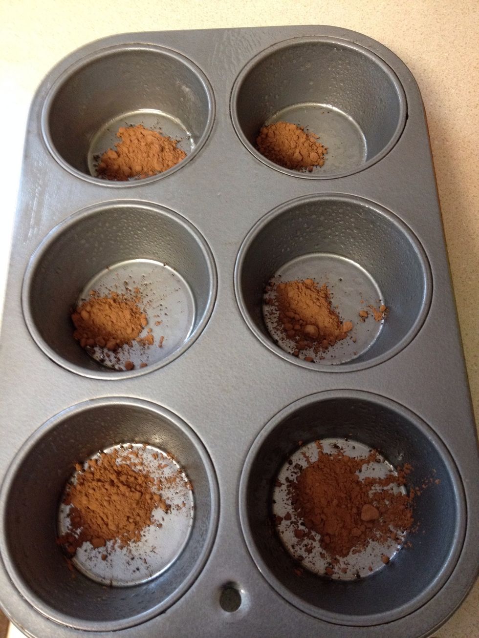 Put cocoa powder in the bottom of each tin and tap the pan to even coat the bottoms and sides