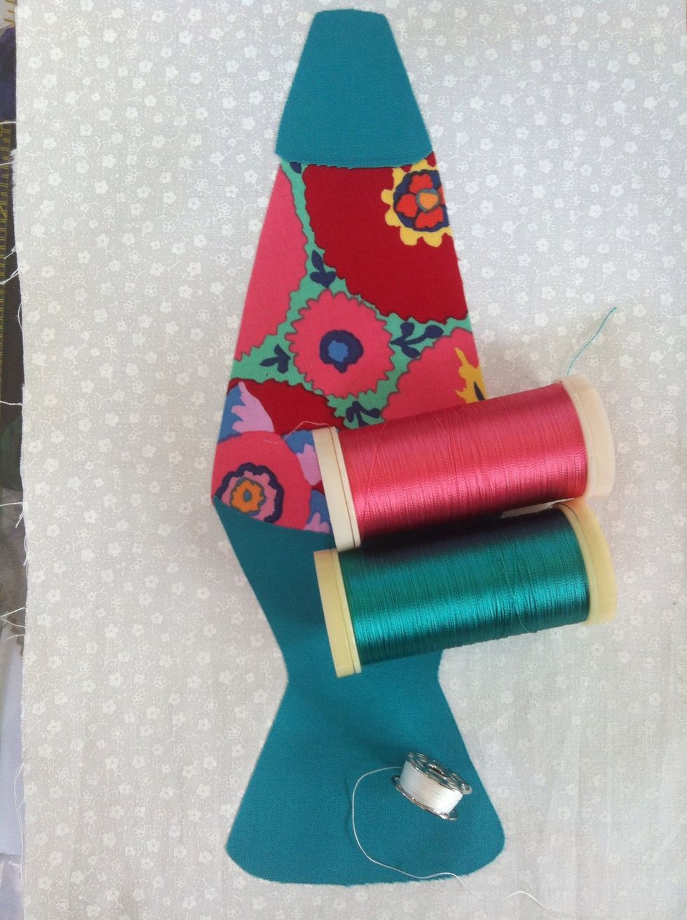 Put cotton thread in bobbin for best result. Can match the top thread OR be a neutral color. I'll stitch the print (Pink) first then stitch around the solid base (Green) on my Lava Lamp quilt block.