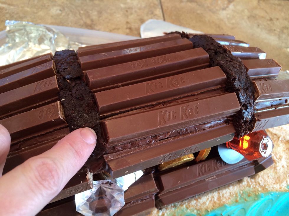 Put cupcake scraps in the spaces between rows of Kit kats.