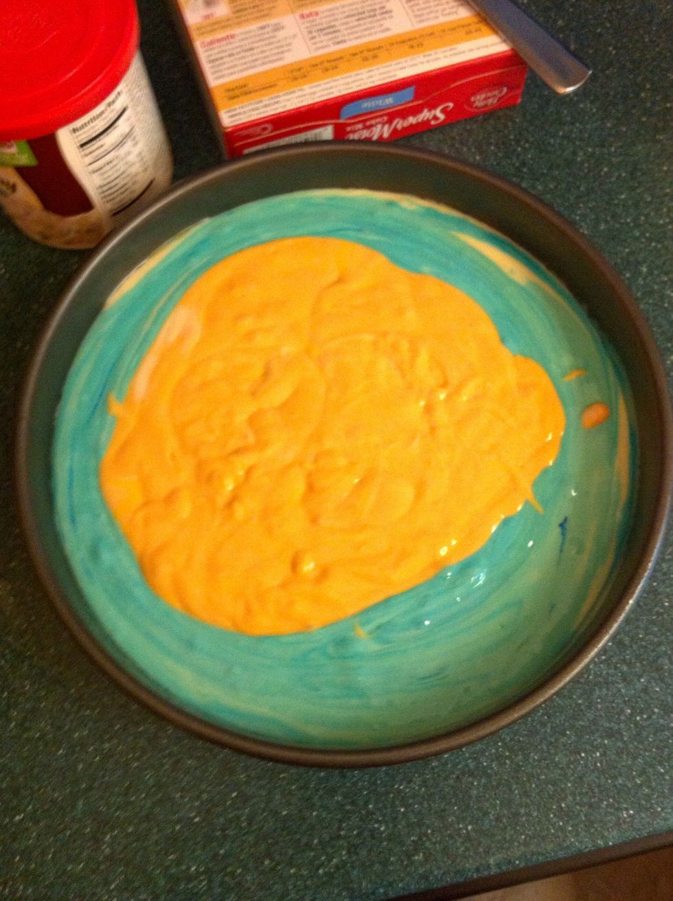 Put each one by one into the round (greased with butter so the cake doesn't stick) pan. They shouldn't be mixed yet.