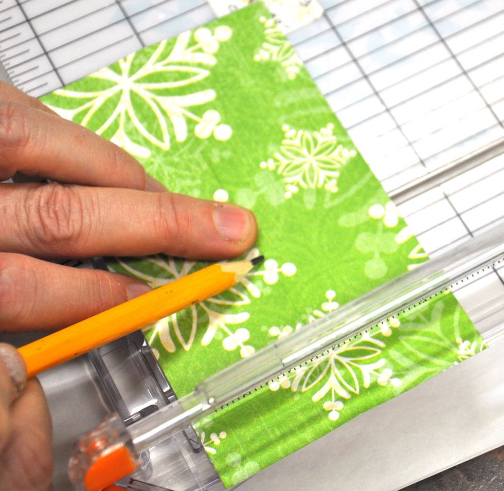 Put each piece into your trimmer and with a pencil make a mark at the three inch point on the middle fold line.