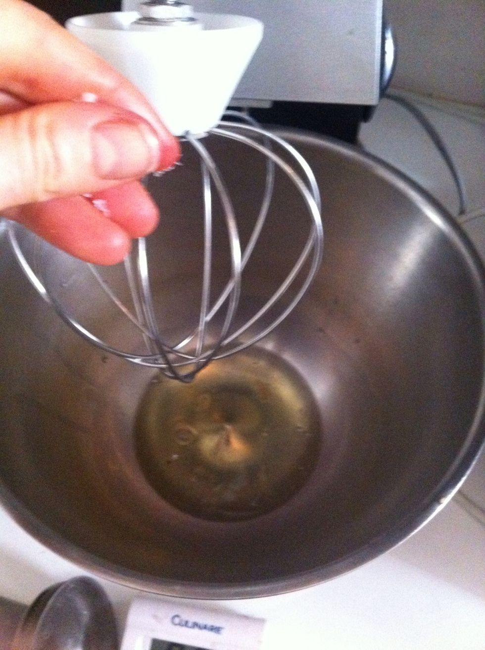 Put egg whites in a clean bowl and whisk with an electric whisk. Add a pinch of sugar.