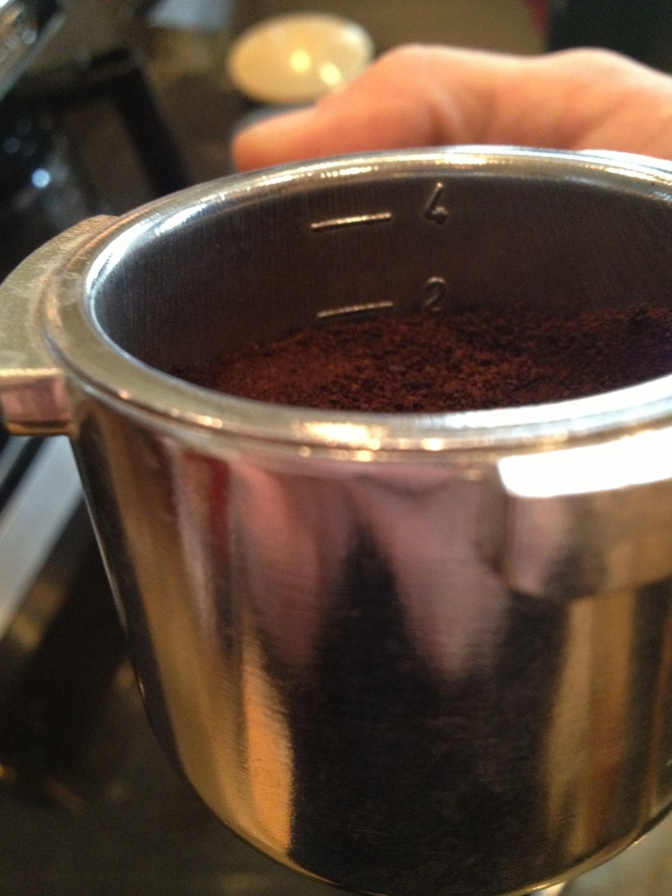 Put espresso into metal cup