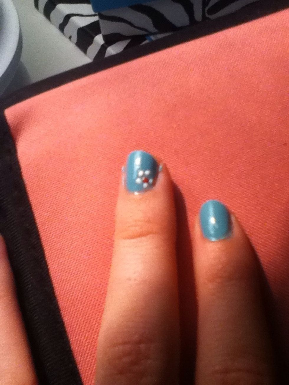 Put five dots around the middle dot. These are the petals.