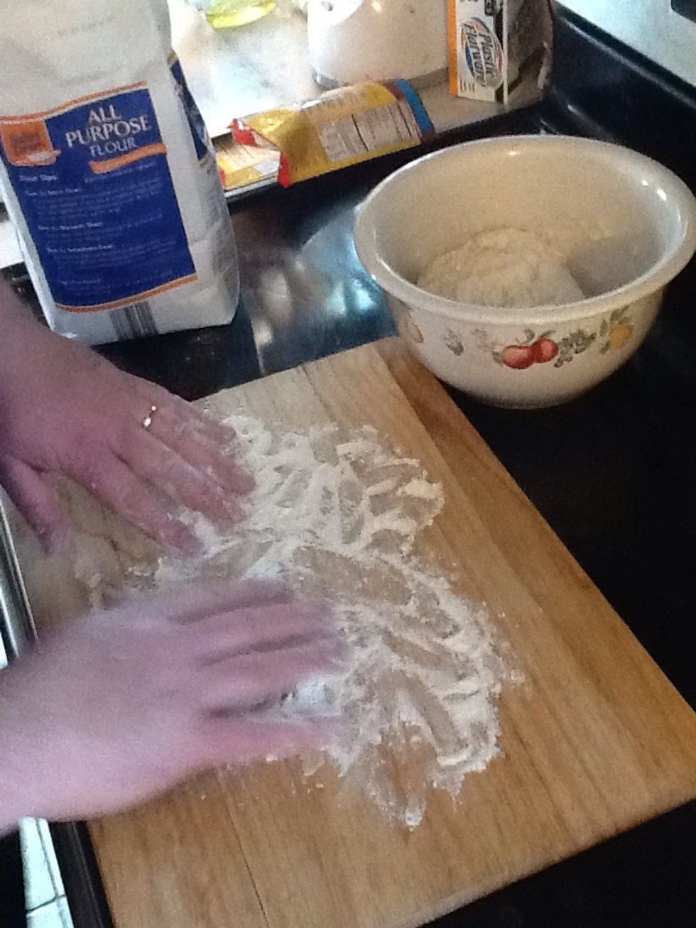 Put flower on cutting board and hands.